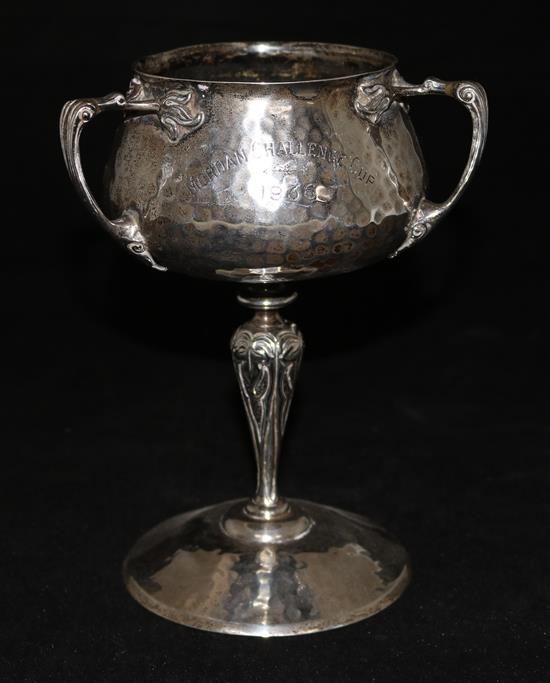 An Art Nouveau planished silver three handled pedestal presentation cup by Alstons & Hallum, 17 oz.